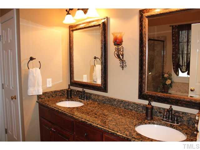 5101 Bartons Enclave Lane Raleigh, NC 27613 - Photo 14 of 25 a bathroom with a granite countertop sink and a mirror