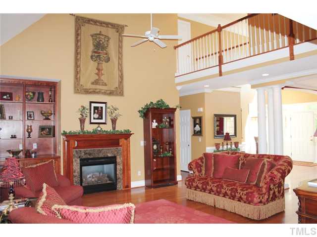 5101 Bartons Enclave Lane Raleigh, NC 27613 - Photo 5 of 25 a living room with furniture a flat screen tv and a fireplace