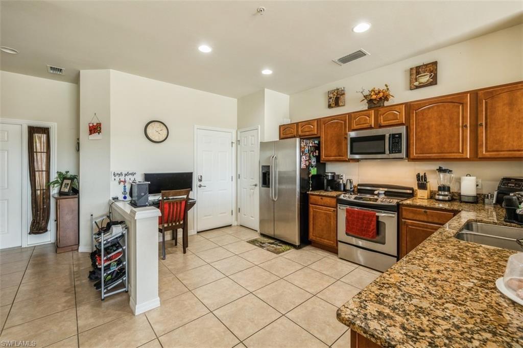 16117 Ravina Way, Unit 33 Naples, FL 34110 - Photo 6 of 25 Kitchen and Garage exit