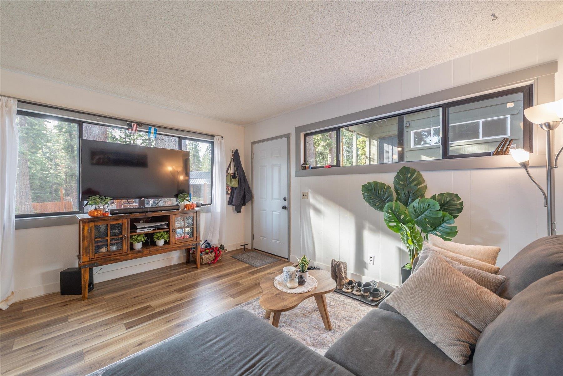 6917 Toyon Road Tahoe Vista, CA 96148 - Photo 13 of 25 a living room with furniture and a flat screen tv