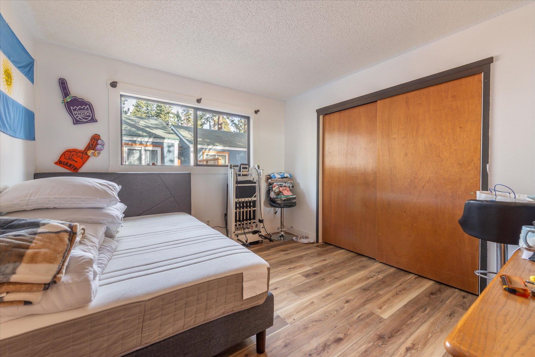 6917 Toyon Road Tahoe Vista, CA 96148 - Photo 18 of 25 a bedroom with a bed and a window