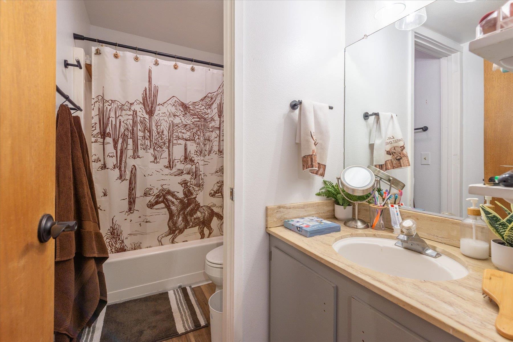 6917 Toyon Road Tahoe Vista, CA 96148 - Photo 19 of 25 a bathroom with a granite countertop sink toilet and shower