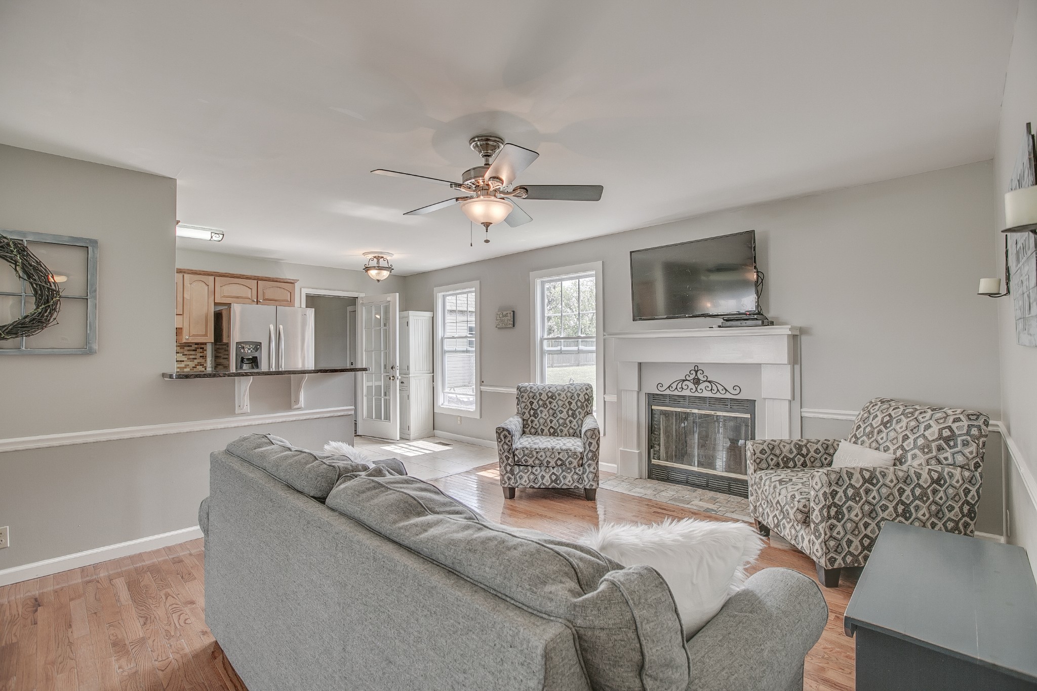7953 Franklin Road Murfreesboro, TN 37128 - Photo 3 of 26 a living room with furniture a fireplace and a flat screen tv