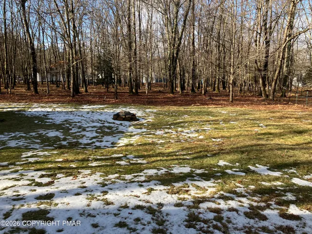 a swimming pool with outdoor seating and yard