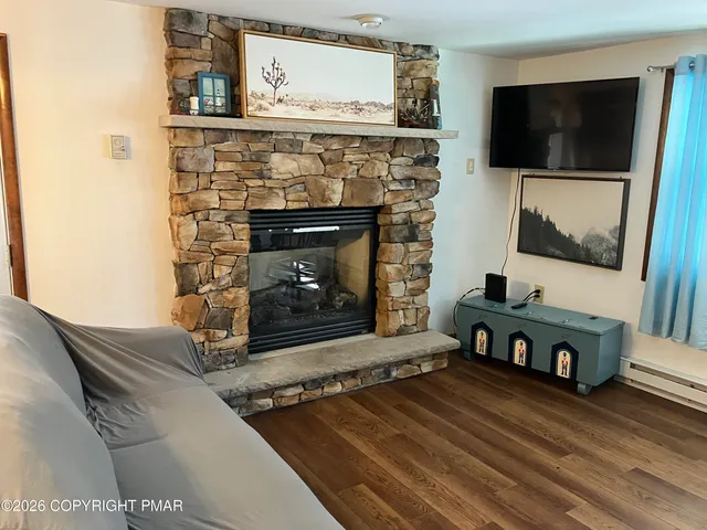 a living room with a fireplace and a flat screen tv