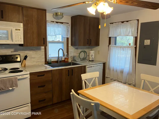 a kitchen with a sink a stove a refrigerator and cabinets
