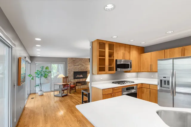 a kitchen with stainless steel appliances granite countertop a sink a stove and a refrigerator