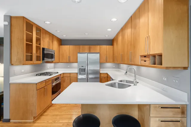 a kitchen with stainless steel appliances a sink and a refrigerator