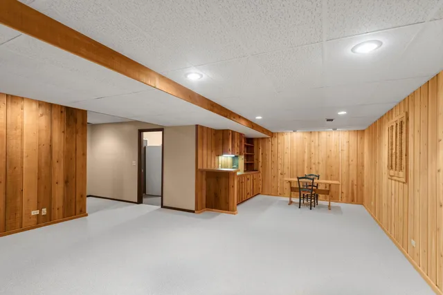 a kitchen that has a lot of cabinets in it and wooden floors