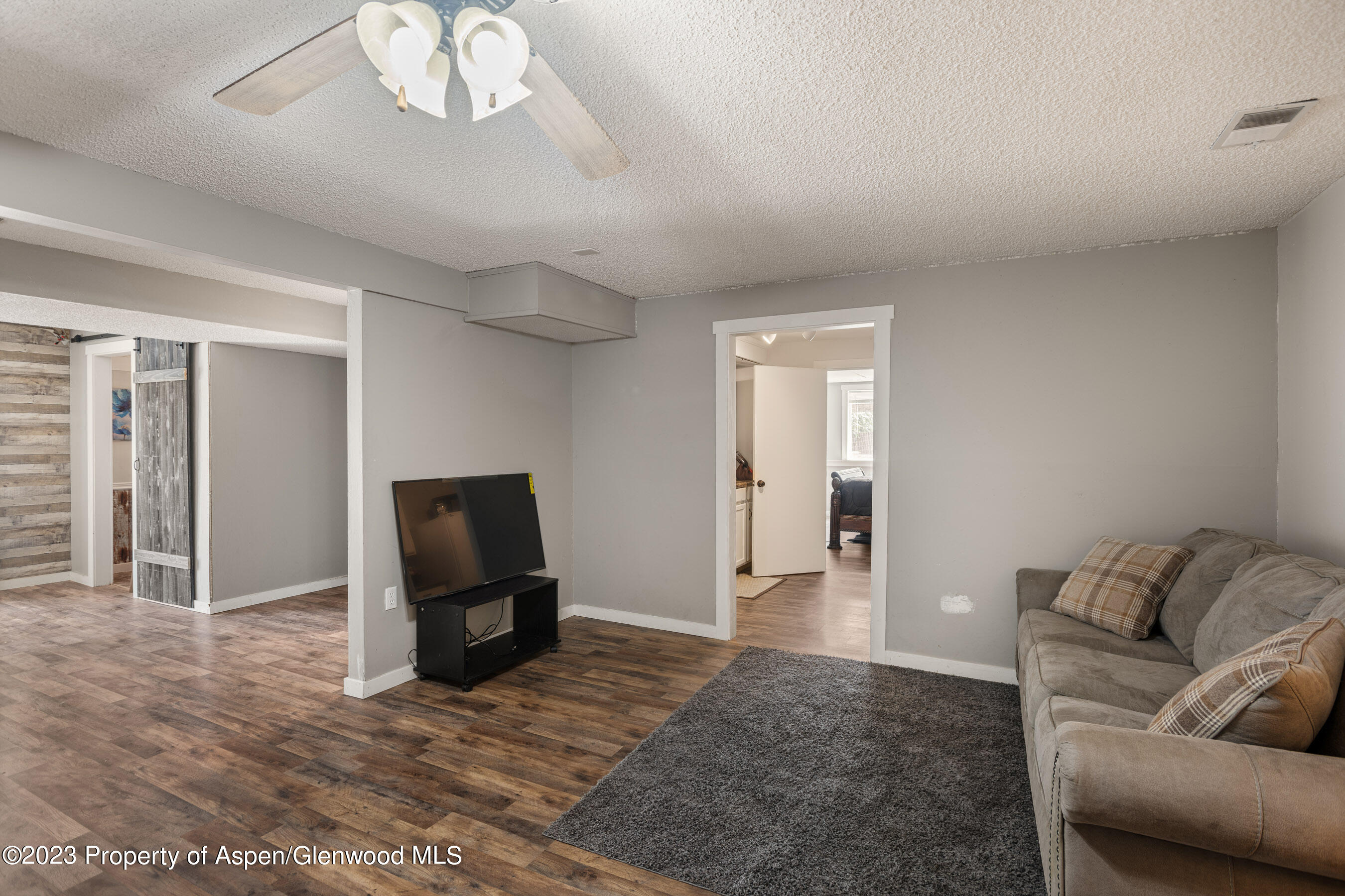 1332 Arabian Avenue Rifle, CO 81650 - Photo 20 of 23 a living room with furniture and a chandelier