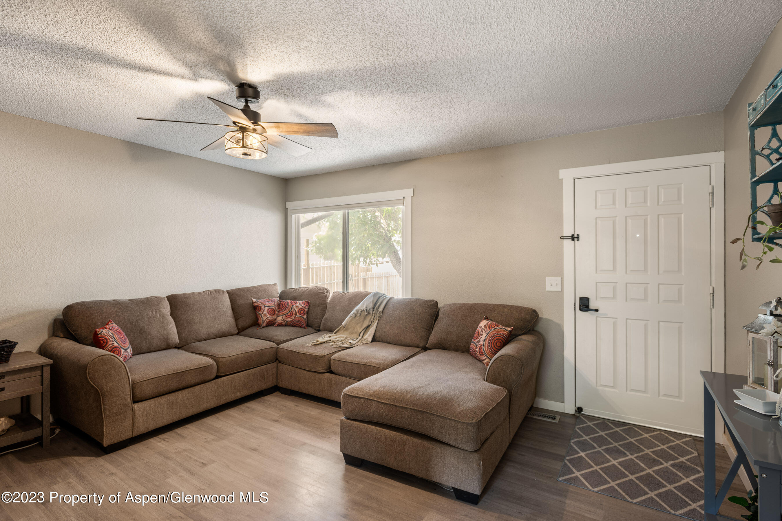 1332 Arabian Avenue Rifle, CO 81650 - Photo 8 of 23 a living room with furniture a ceiling fan and a window