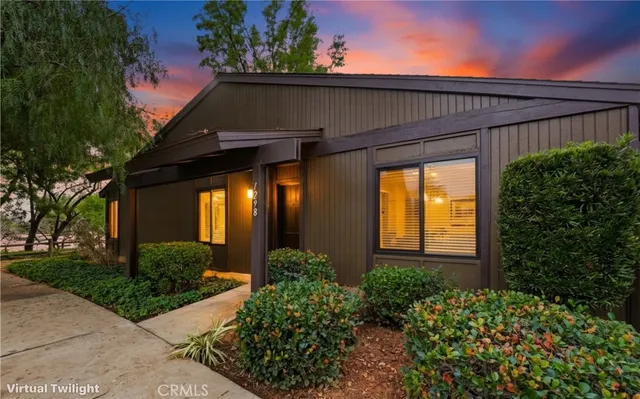 front view of a house with potted plants