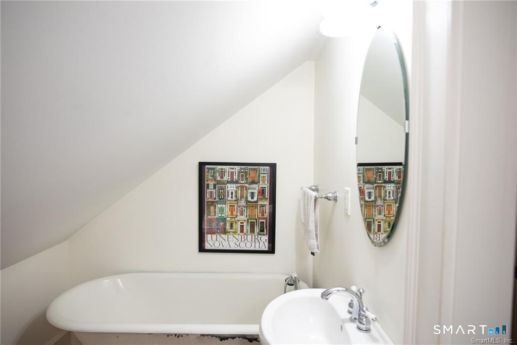57 Mill Rock Road Hamden, CT 06517 - Photo 20 of 24 a bathroom with a white tub and shower