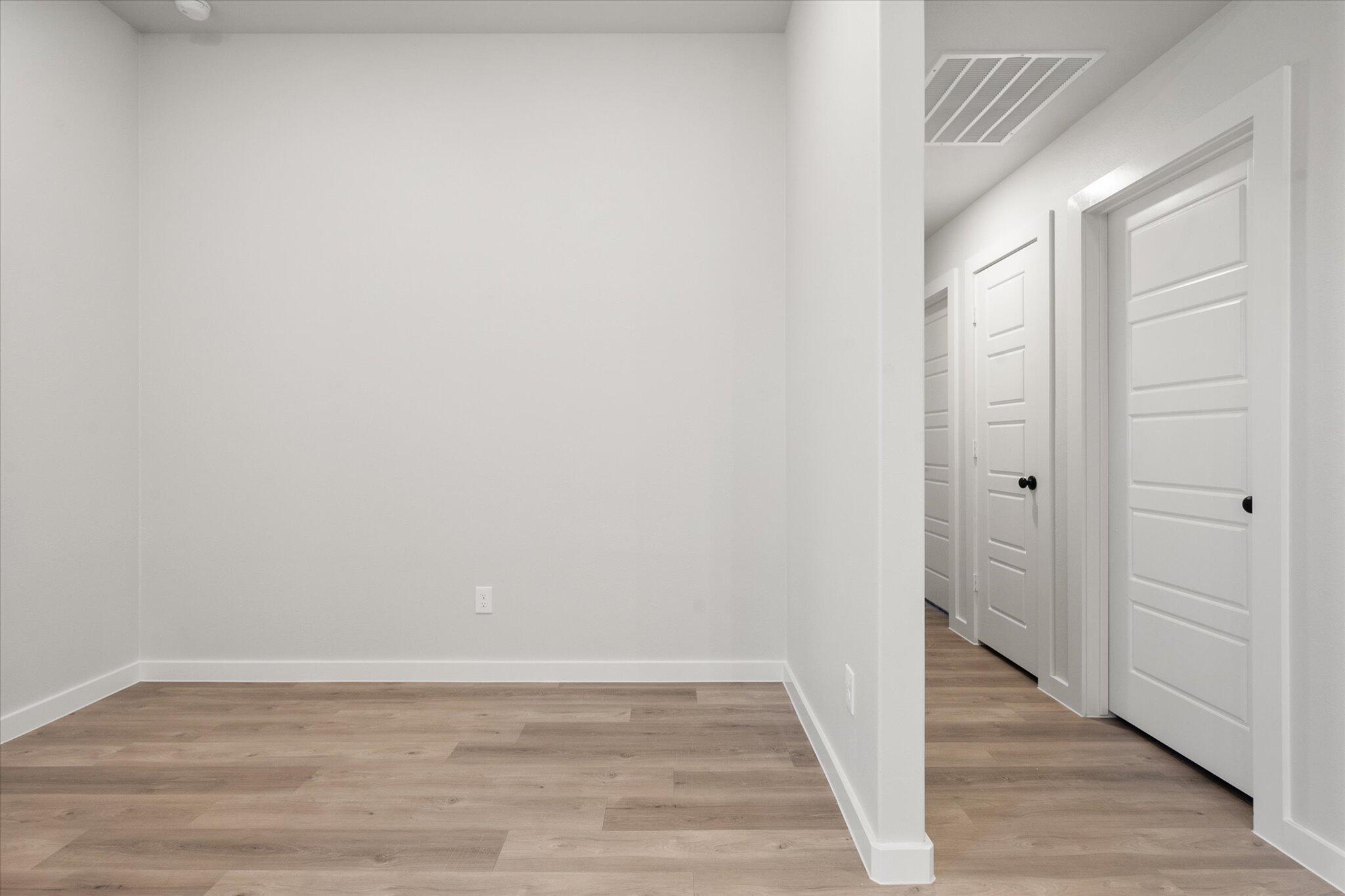 8605 29th Street Lubbock, TX 79407 - Photo 12 of 21 a view of an empty room with wooden floor