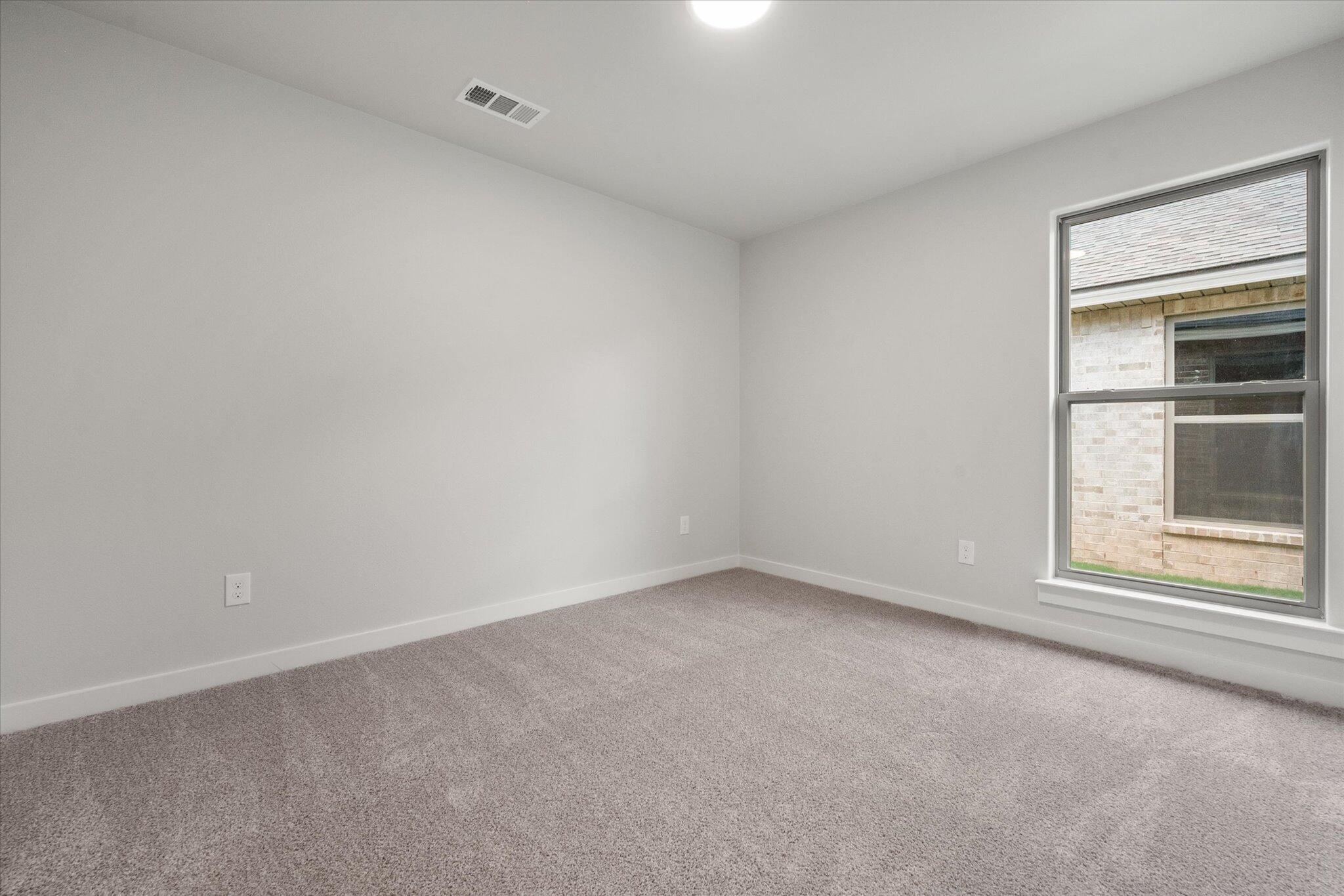 8605 29th Street Lubbock, TX 79407 - Photo 17 of 21 an empty room with a window