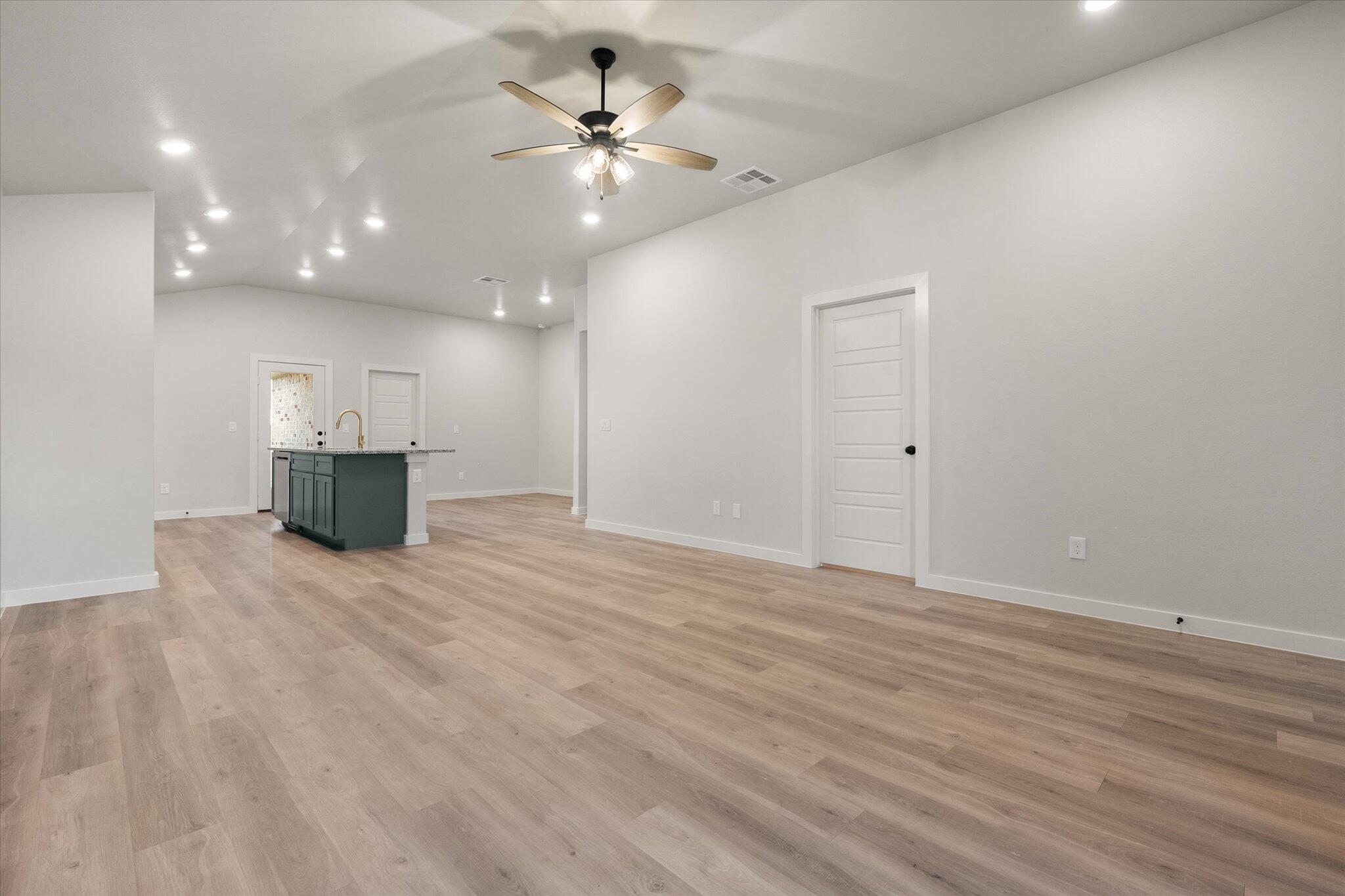 8605 29th Street Lubbock, TX 79407 - Photo 4 of 21 a view of an empty room with a fireplace