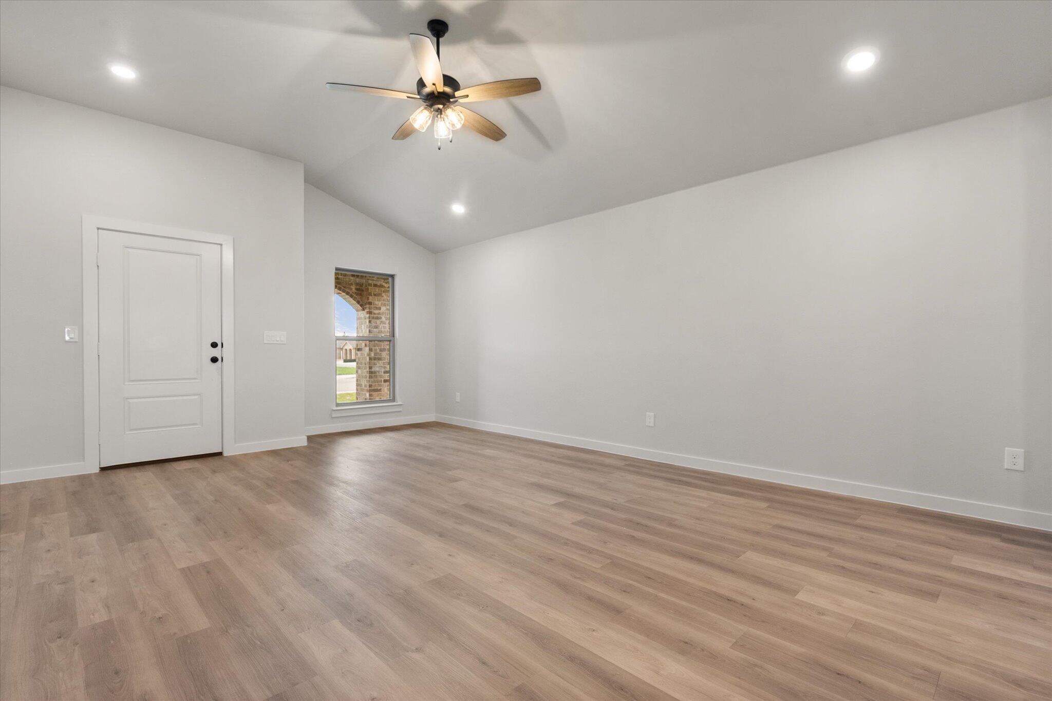8605 29th Street Lubbock, TX 79407 - Photo 6 of 21 wooden floor in an empty room with a window
