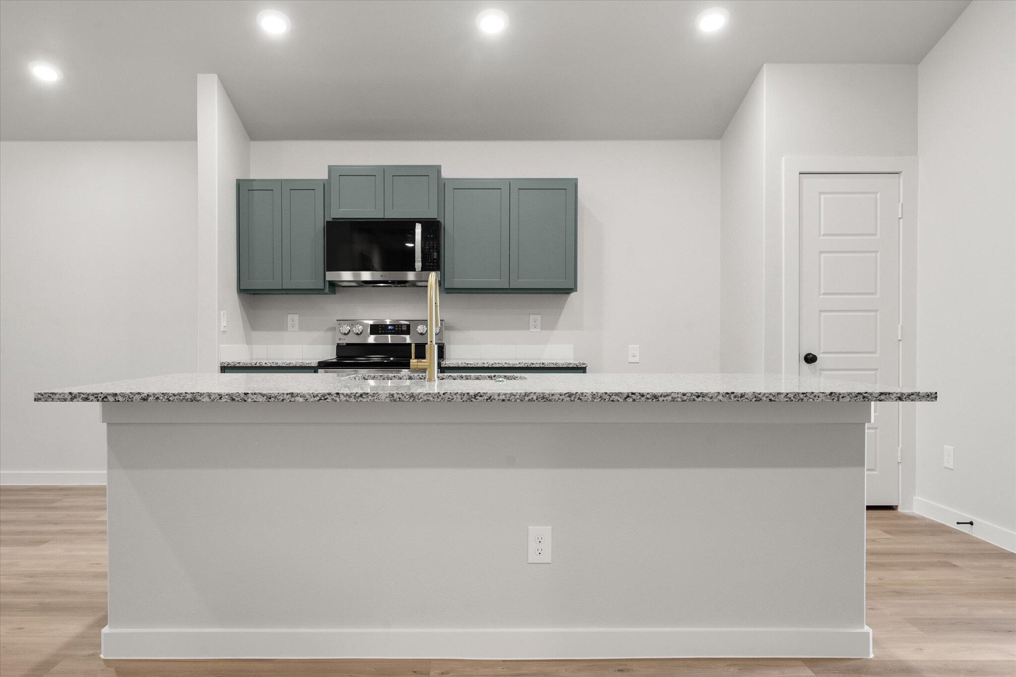 8605 29th Street Lubbock, TX 79407 - Photo 8 of 21 a view of a kitchen with kitchen island sink stainless steel appliances and cabinets