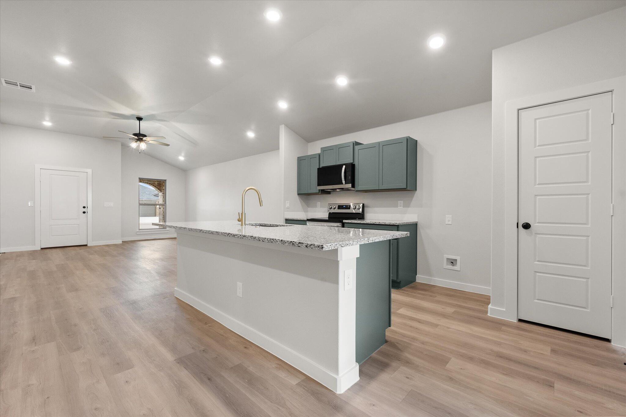 8605 29th Street Lubbock, TX 79407 - Photo 9 of 21 a view of kitchen with sink microwave and refrigerator
