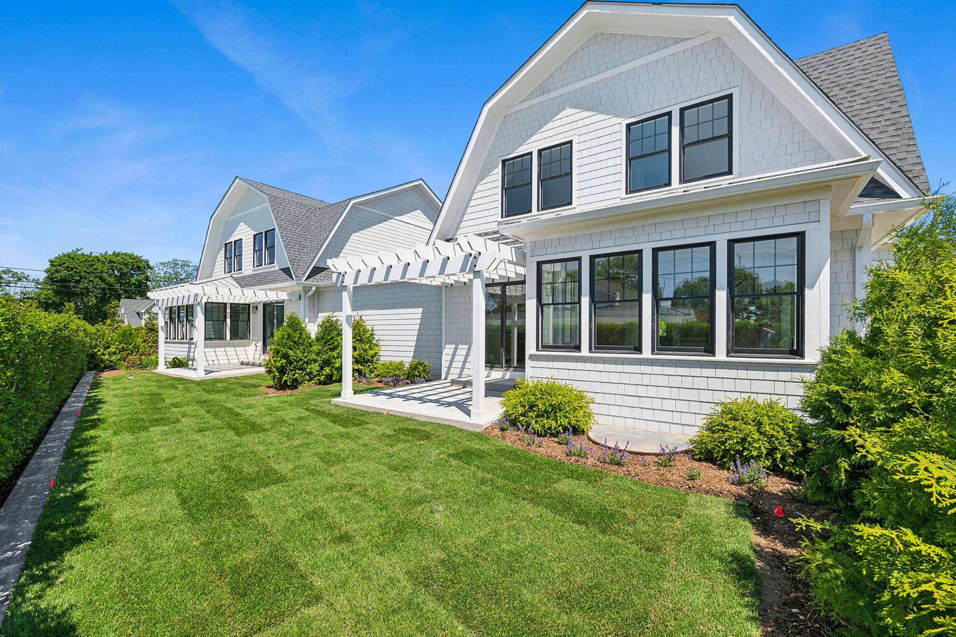12 Depot Road, Unit 1102 Westhampton Beach, NY 11978 - Photo 1 of 20 a front view of a house with a yard