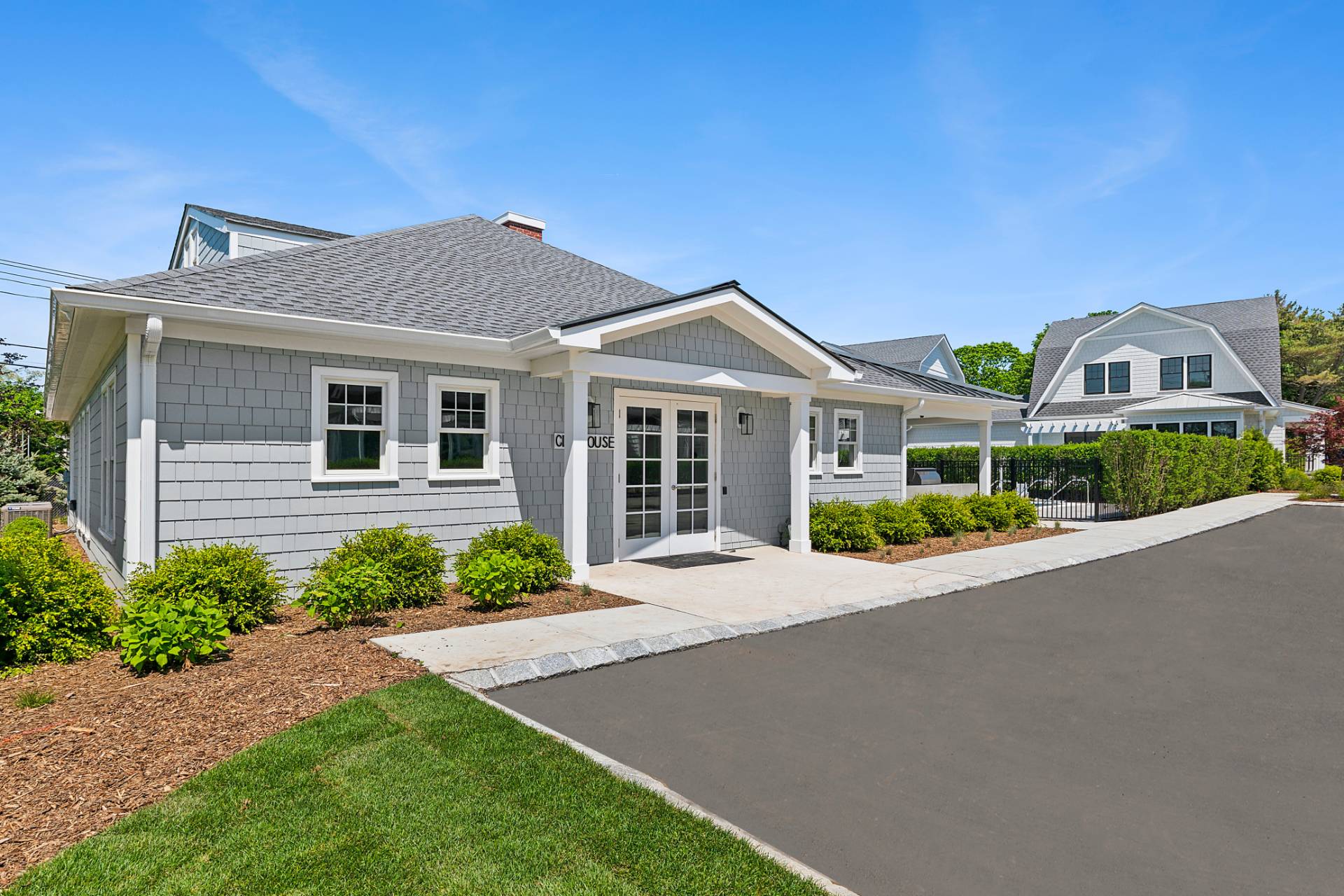 12 Depot Road, Unit 1102 Westhampton Beach, NY 11978 - Photo 20 of 20 a front view of a house with a garden