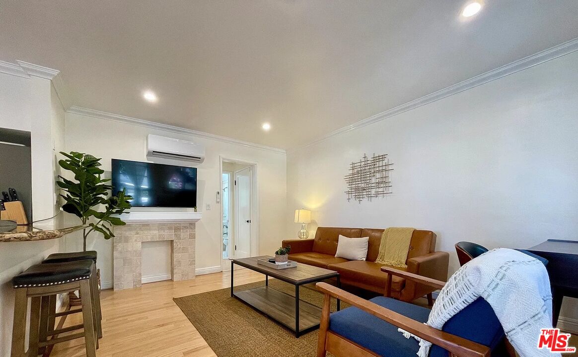 1212 10th Street, Unit 2 Santa Monica, CA 90401 - Photo 13 of 29 a living room with furniture and a flat screen tv