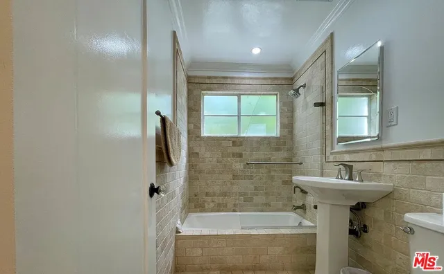 a bathroom with a sink and shower