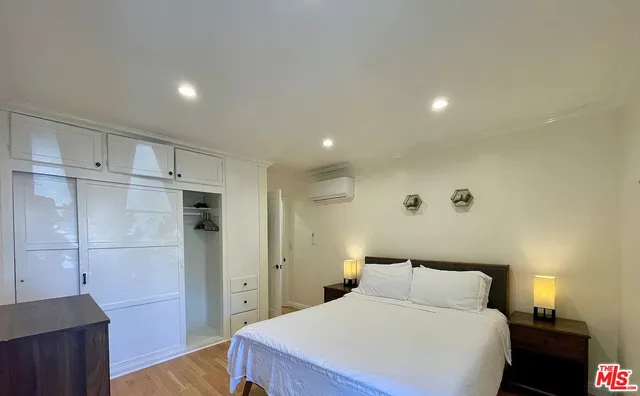 a bedroom with a bed and a walk in closet