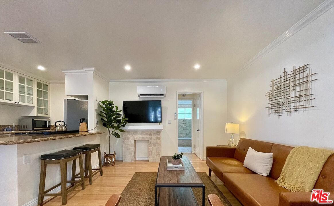 1212 10th Street, Unit 2 Santa Monica, CA 90401 - Photo 9 of 29 a living room with furniture and a flat screen tv