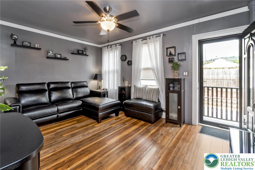 365 Rock Street Easton, PA 18042 - Photo 5 of 50 Laminate flooring and a ceiling fan create a comfortable atmosphere in this inviting living space.