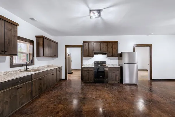 a kitchen with granite countertop cabinets and steel stainless steel appliances