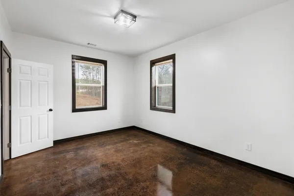 a view of a big room with closet and windows