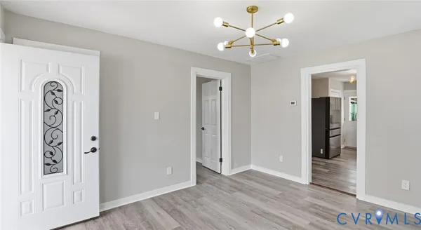 a view of an entryway with wooden floor