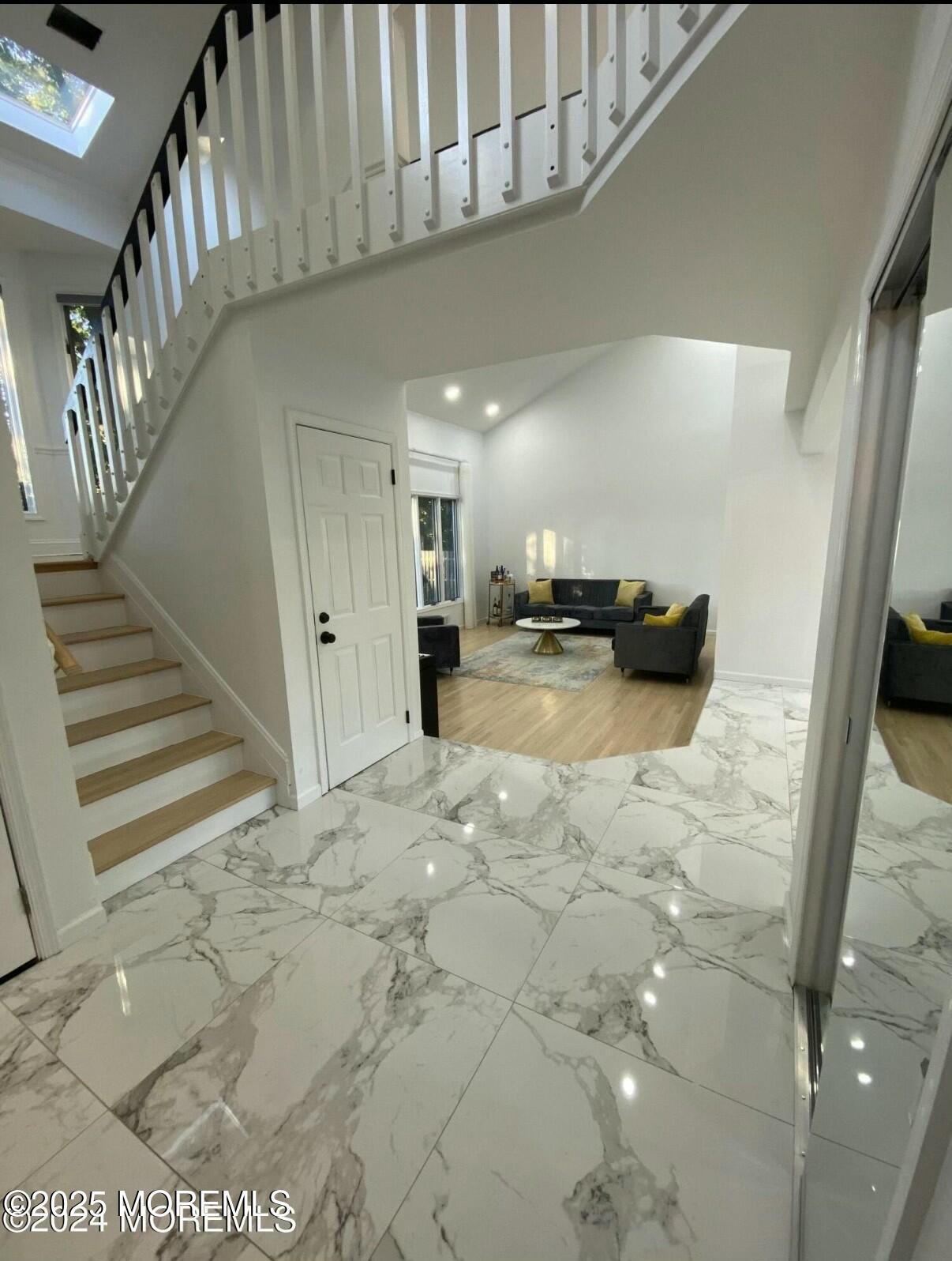 604 Van Note Parkway Oakhurst, NJ 07755 - Photo 11 of 19 a view of a hallway to a livingroom with furniture and a kitchen
