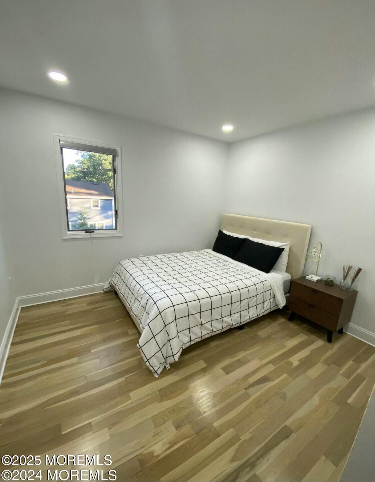 604 Van Note Parkway Oakhurst, NJ 07755 - Photo 13 of 19 a bedroom with a bed and wooden floor