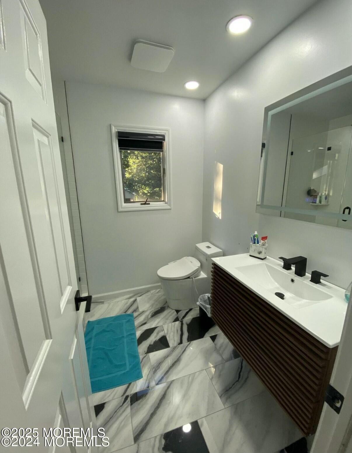 604 Van Note Parkway Oakhurst, NJ 07755 - Photo 17 of 19 a bathroom with a sink mirror and toilet