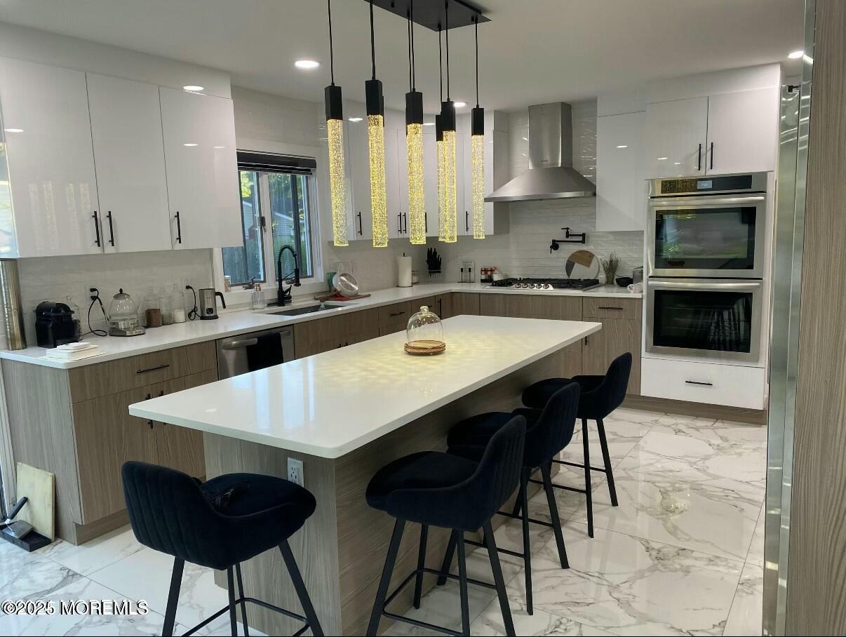 604 Van Note Parkway Oakhurst, NJ 07755 - Photo 2 of 19 a kitchen with stainless steel appliances granite countertop a sink a stove a refrigerator and island with wooden floor