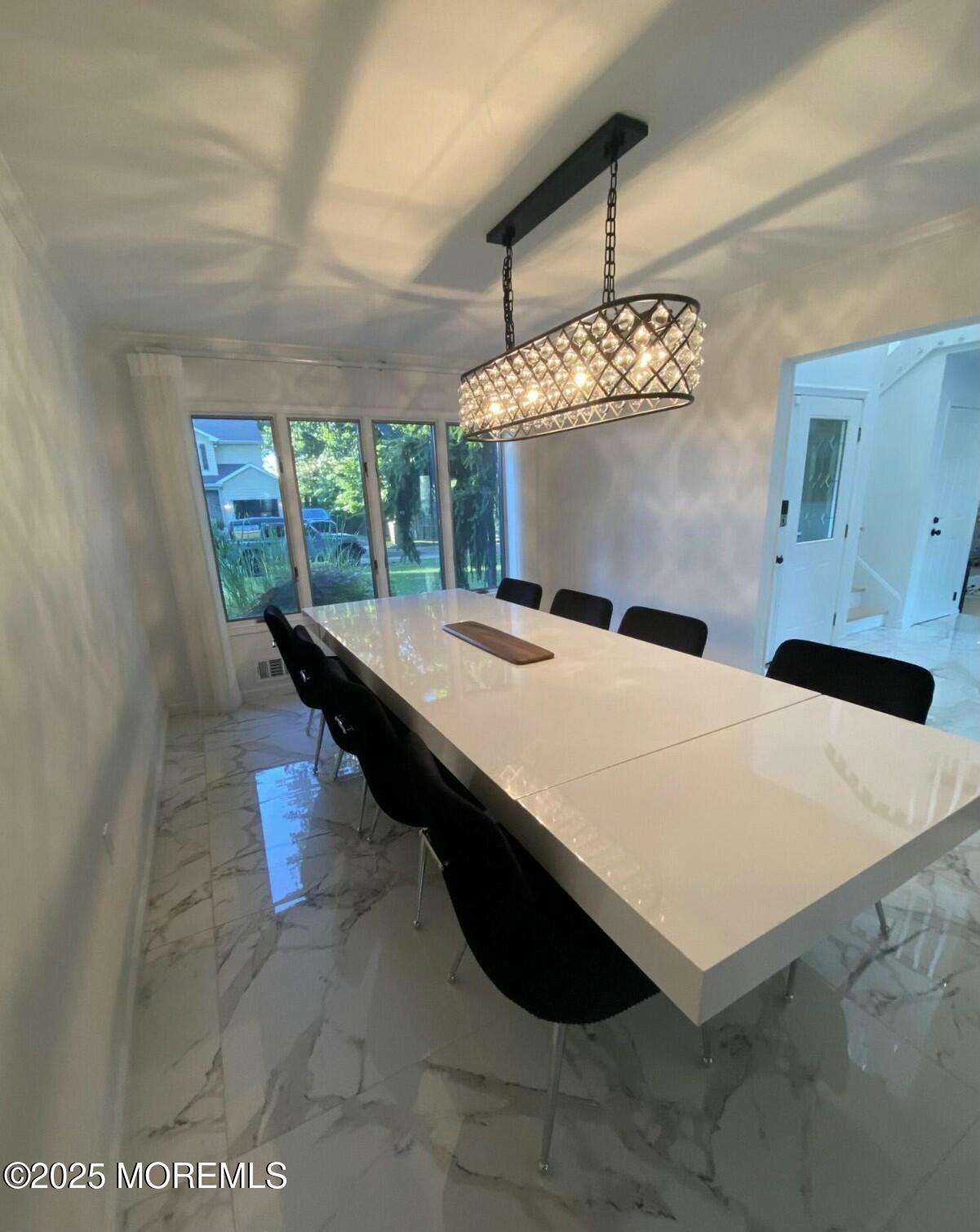 604 Van Note Parkway Oakhurst, NJ 07755 - Photo 6 of 19 a dining room with table and chandelier