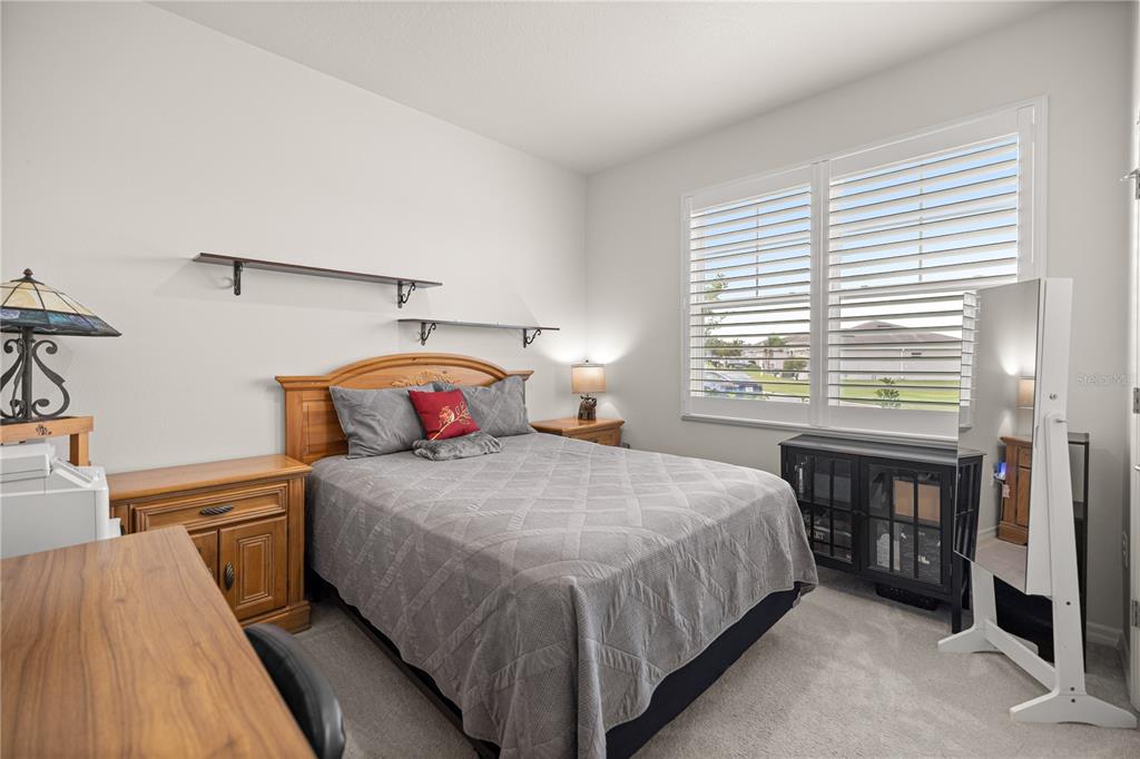 6125 Southwest 88th Loop Ocala, FL 34476 - Photo 16 of 29 a bedroom with a bed and a table