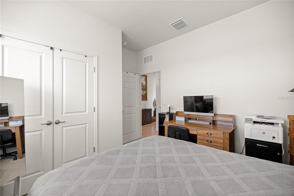 6125 Southwest 88th Loop Ocala, FL 34476 - Photo 17 of 29 a bedroom with a bed and a flat screen tv