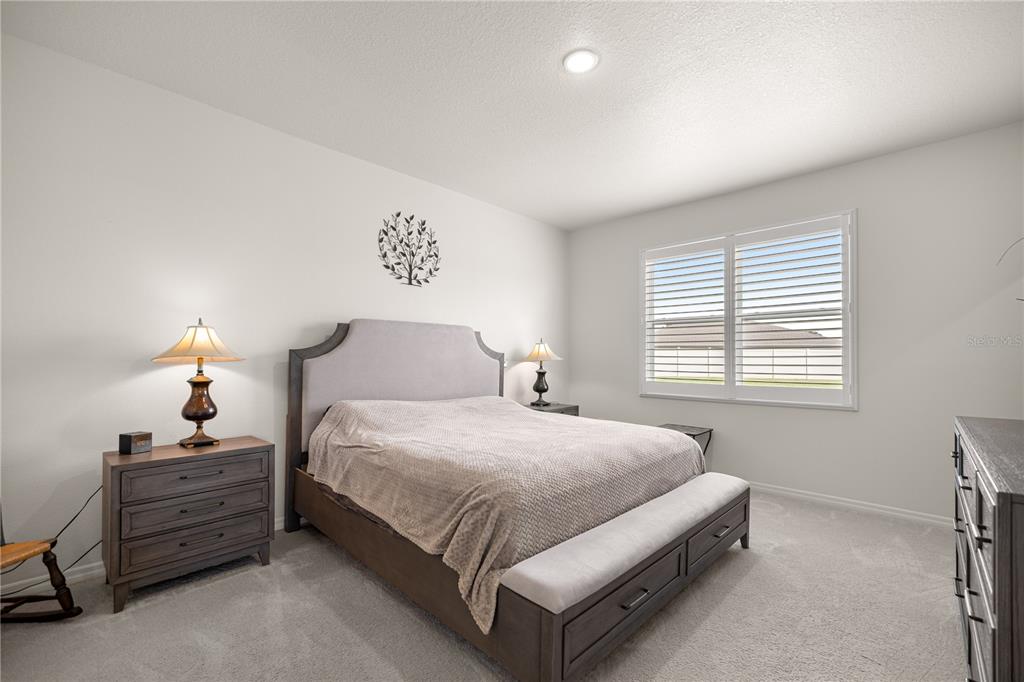 6125 Southwest 88th Loop Ocala, FL 34476 - Photo 19 of 29 a bed room with a bed and a lamp