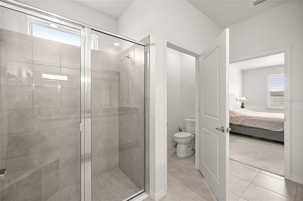 6125 Southwest 88th Loop Ocala, FL 34476 - Photo 22 of 29 a bathroom with a toilet a sink and shower