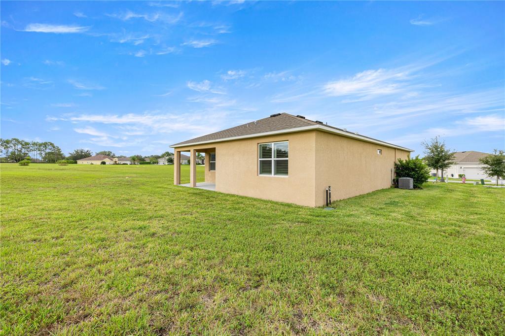 6125 Southwest 88th Loop Ocala, FL 34476 - Photo 25 of 29 a view of a house with a backyard