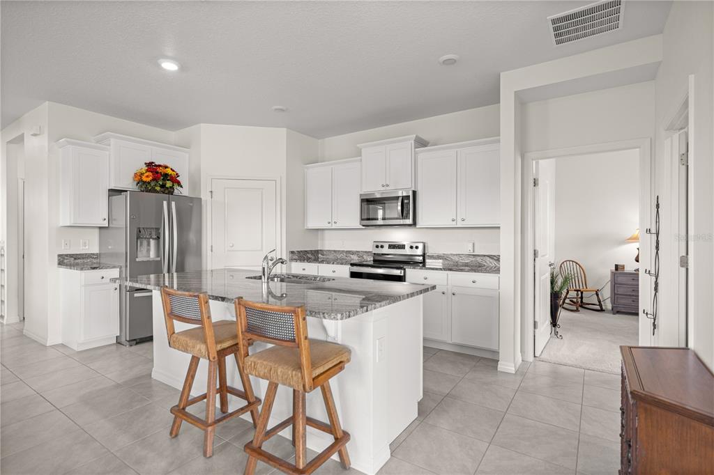 6125 Southwest 88th Loop Ocala, FL 34476 - Photo 9 of 29 a kitchen that has a lot of cabinets in it and appliances