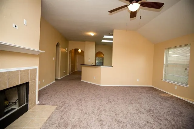 a view of empty room with fireplace