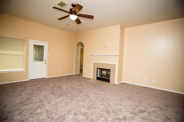 a view of a sink a faucet a fireplace and cabinets