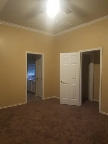 a view of a small space with wooden floor and a window