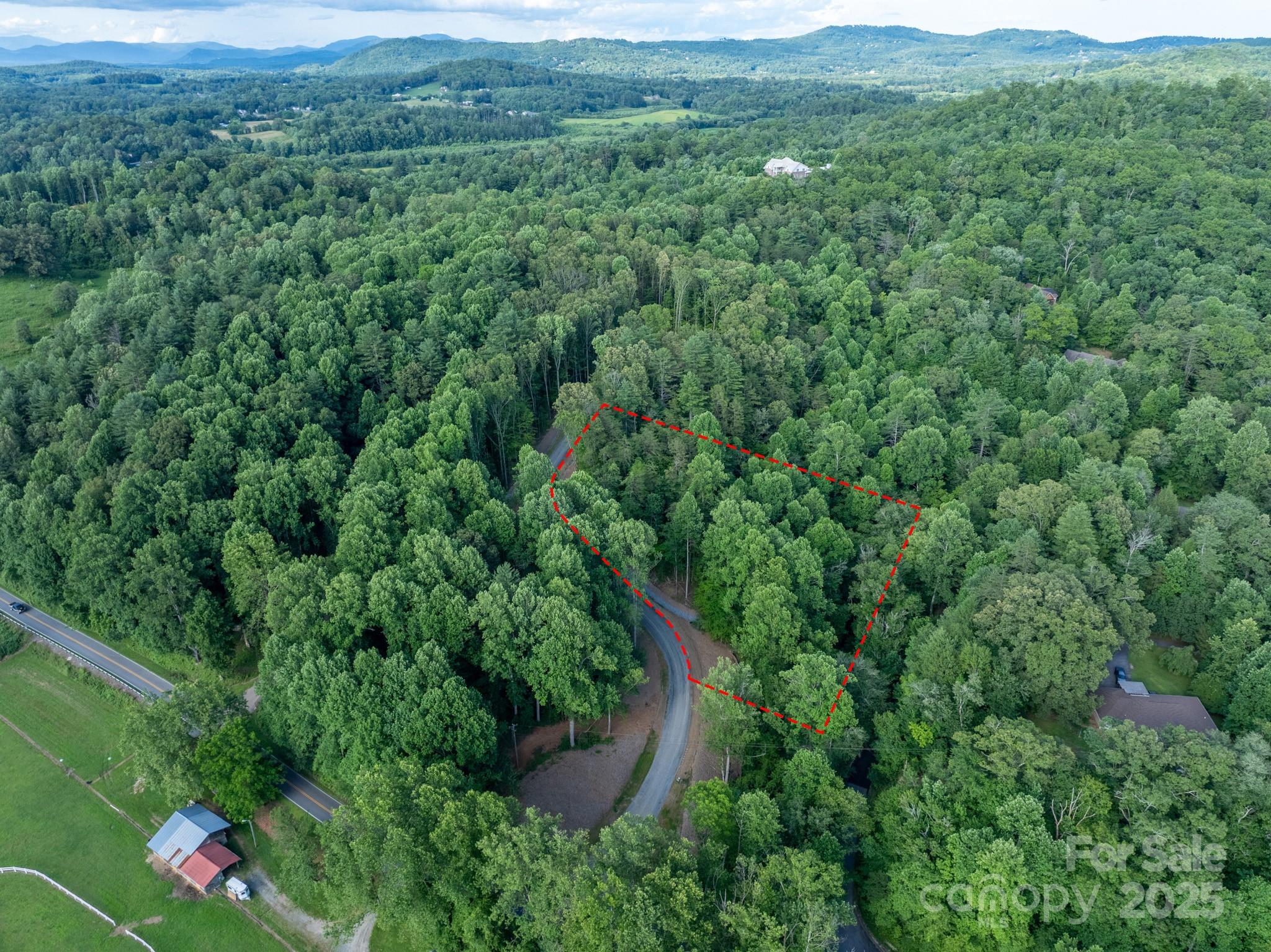 102 Reserve Way, Unit 2 Hendersonville, NC 28739 - Photo 2 of 22 a view of a lush green field with lots of bushes