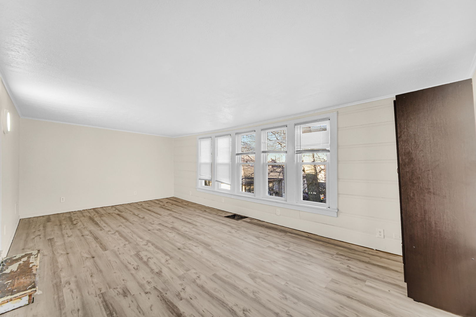 15409 Joliet Road Plainfield, IL 60544 - Photo 15 of 32 an empty room with wooden floor and windows