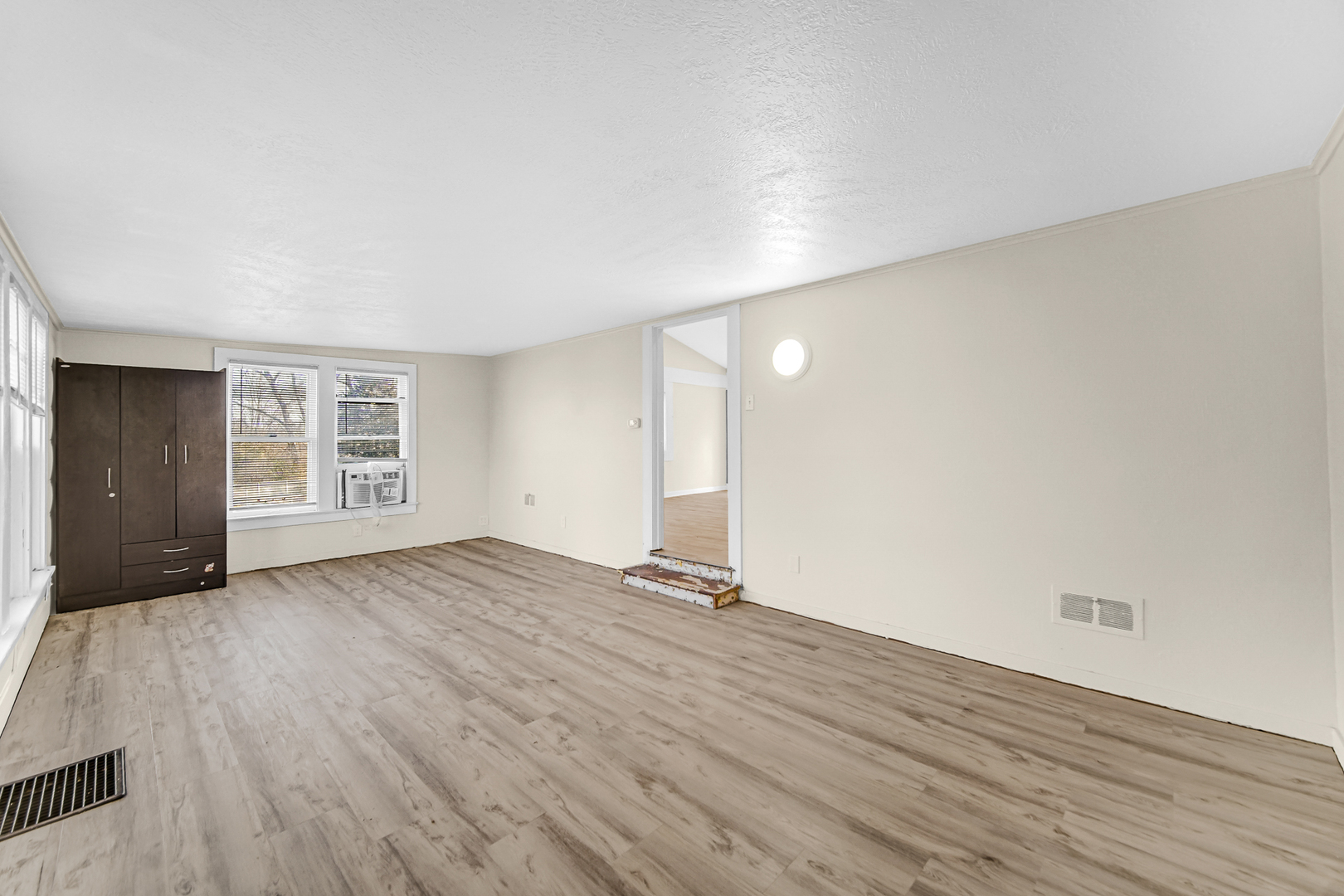 15409 Joliet Road Plainfield, IL 60544 - Photo 16 of 32 a view of an empty room with wooden floor and windows
